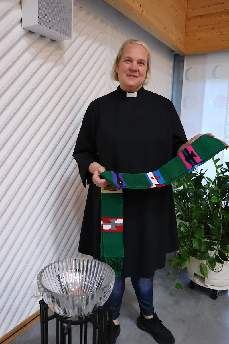 Pia Kähkönen kuljettaa mukanaan värikästä stolaa, jonka hän on saanut lahjaksi.