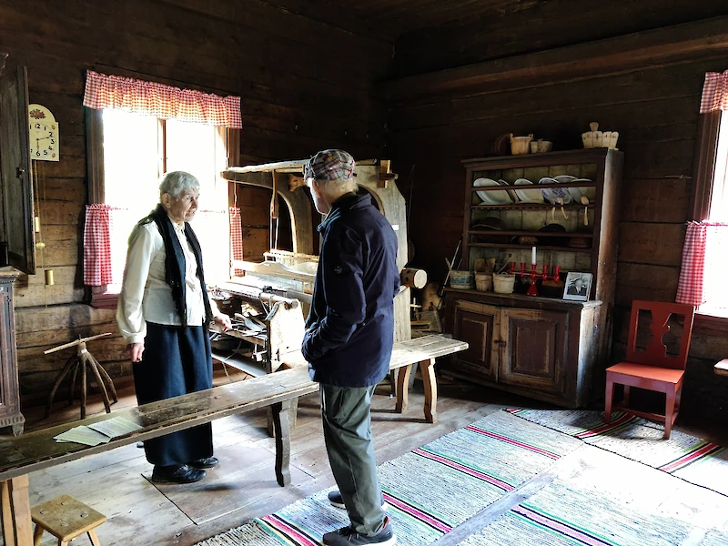 Arkistokuvassa Irma Napola Iitin Kotiseutuyhdistyksestä esittelee Karralan kotiseutaloa.